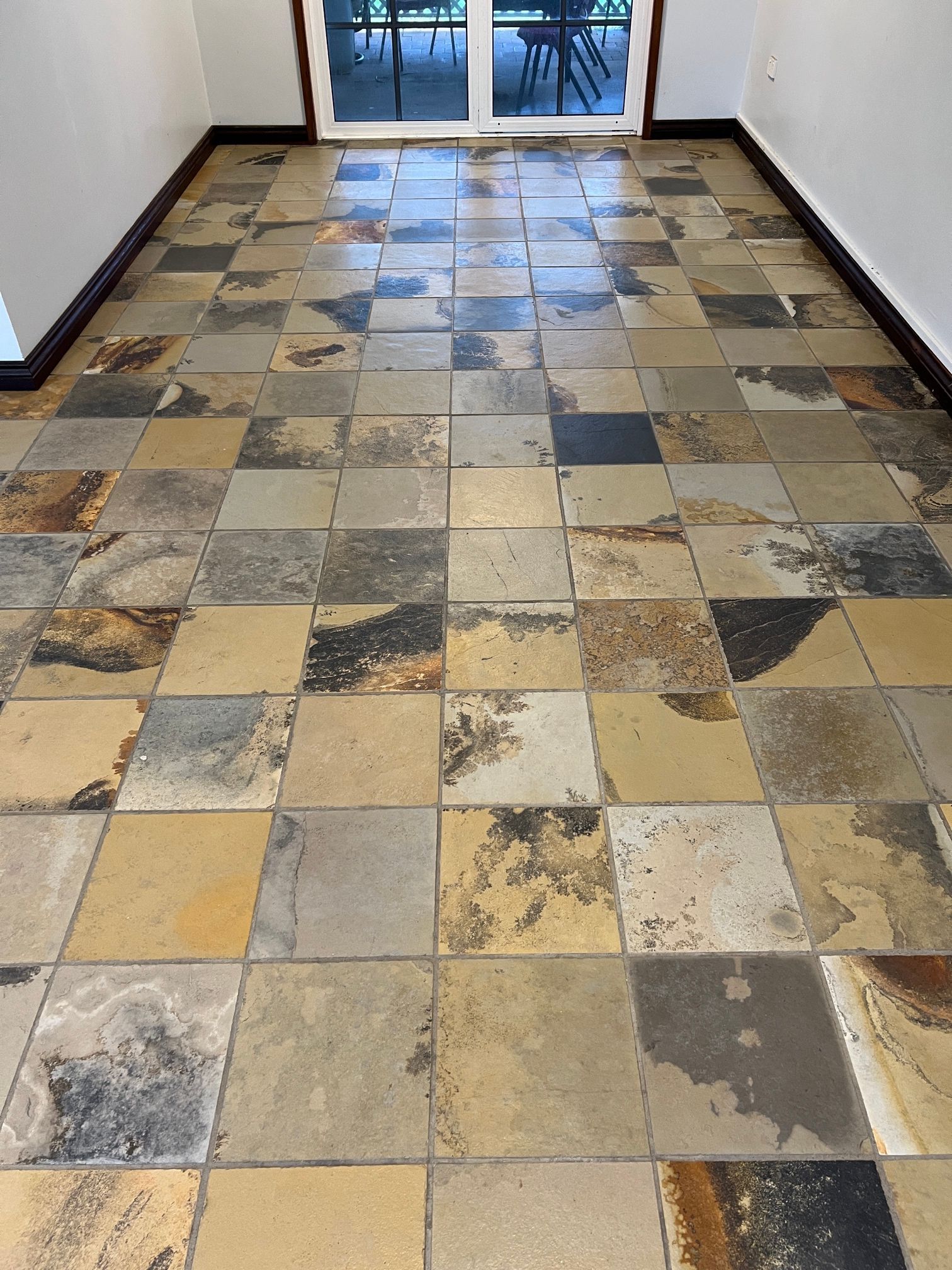 A room with a tiled floor and a sliding glass door.