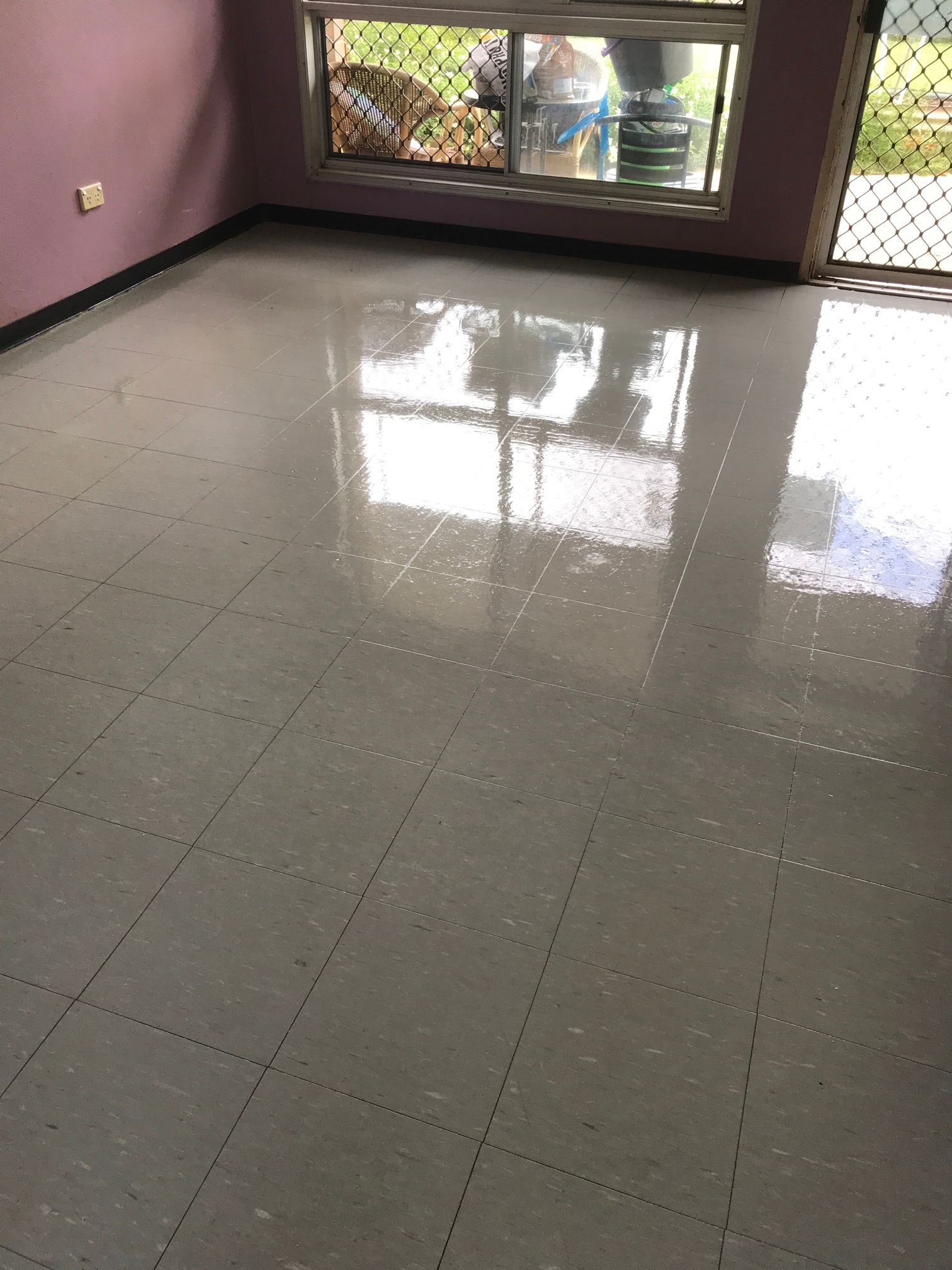 A room with a tiled floor and a window.